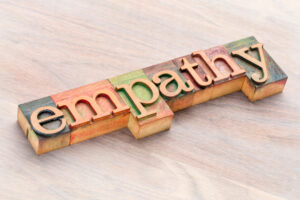 wooden letter blocks spelling out the word ‘empathy’ in multi colors