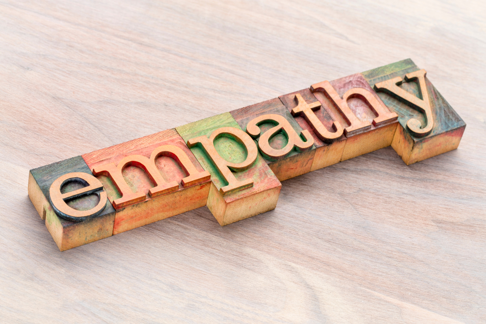 wooden letter blocks spelling out the word ‘empathy’ in multi colors