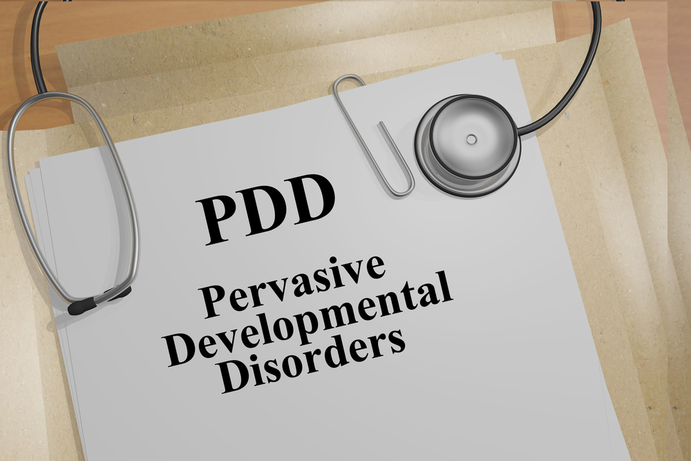 PDD: Pervasive Developmental Disorders with a stethoscope lying on a file folder.